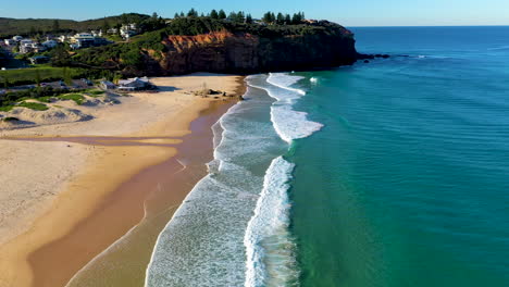 revealing drone shot at redhead beach australia, starting on surf then rising