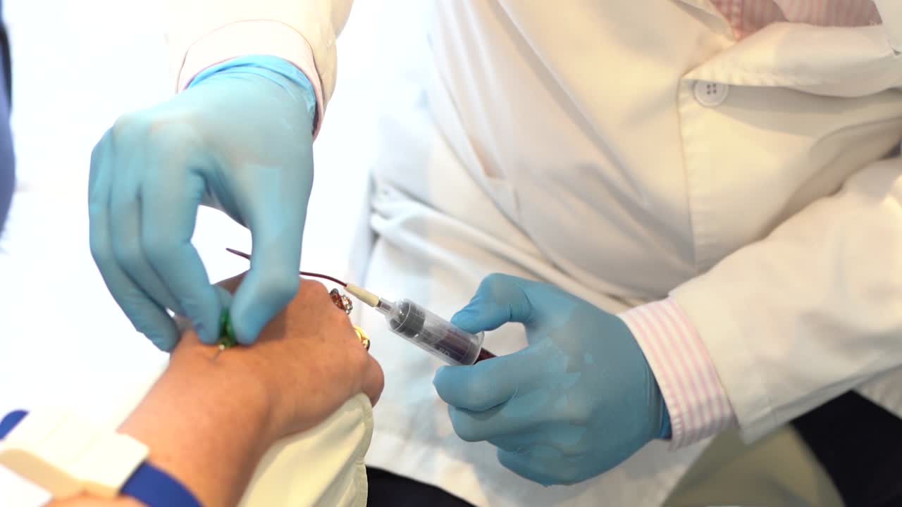 Male Doctor Taking Blood Into A Syringe From A Female Patient During Blood  Donation Procedure Free Stock Video Footage Download Clips