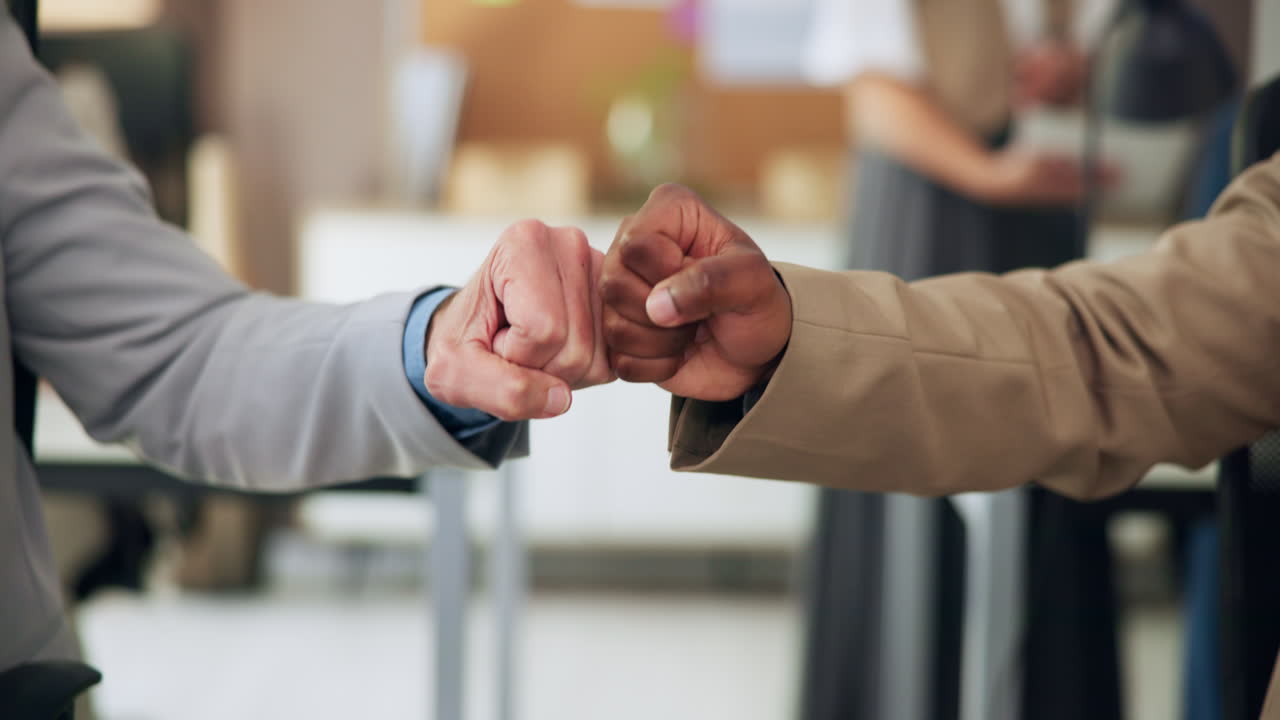 Two Businessmen Exchanging a Fist Bump in an Office