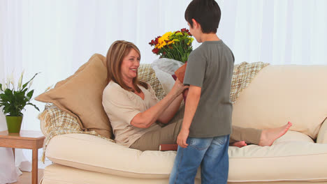 Little-darkhaired-boy-bringing-a-bunch-of-flowers