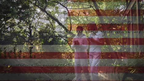 Animation-of-american-flag-and-constitution-text-over-asian-mother-and-daughter-in-garden