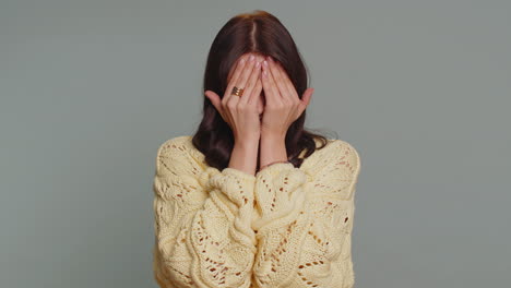 woman covering her face with her hands