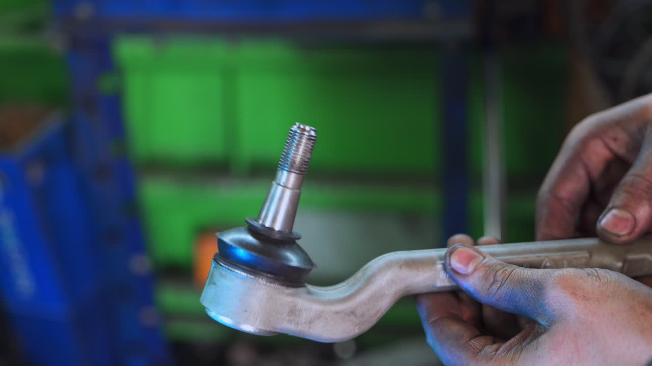 Checking the metal detail for inaccuracies. Turner examining his work. Close up. Blurred background.