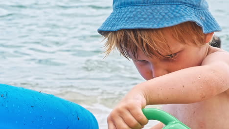 little boy playing near sea