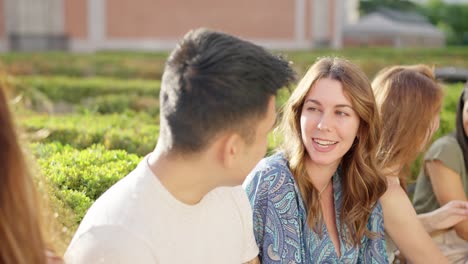 diverse group of friends having a conversation outdoors