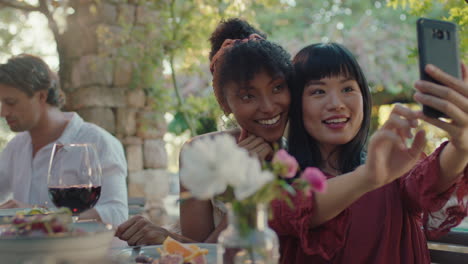 fun girl friends taking photo together using smartphone at dinner party enjoying summer sharing vacation memories on social media 4k