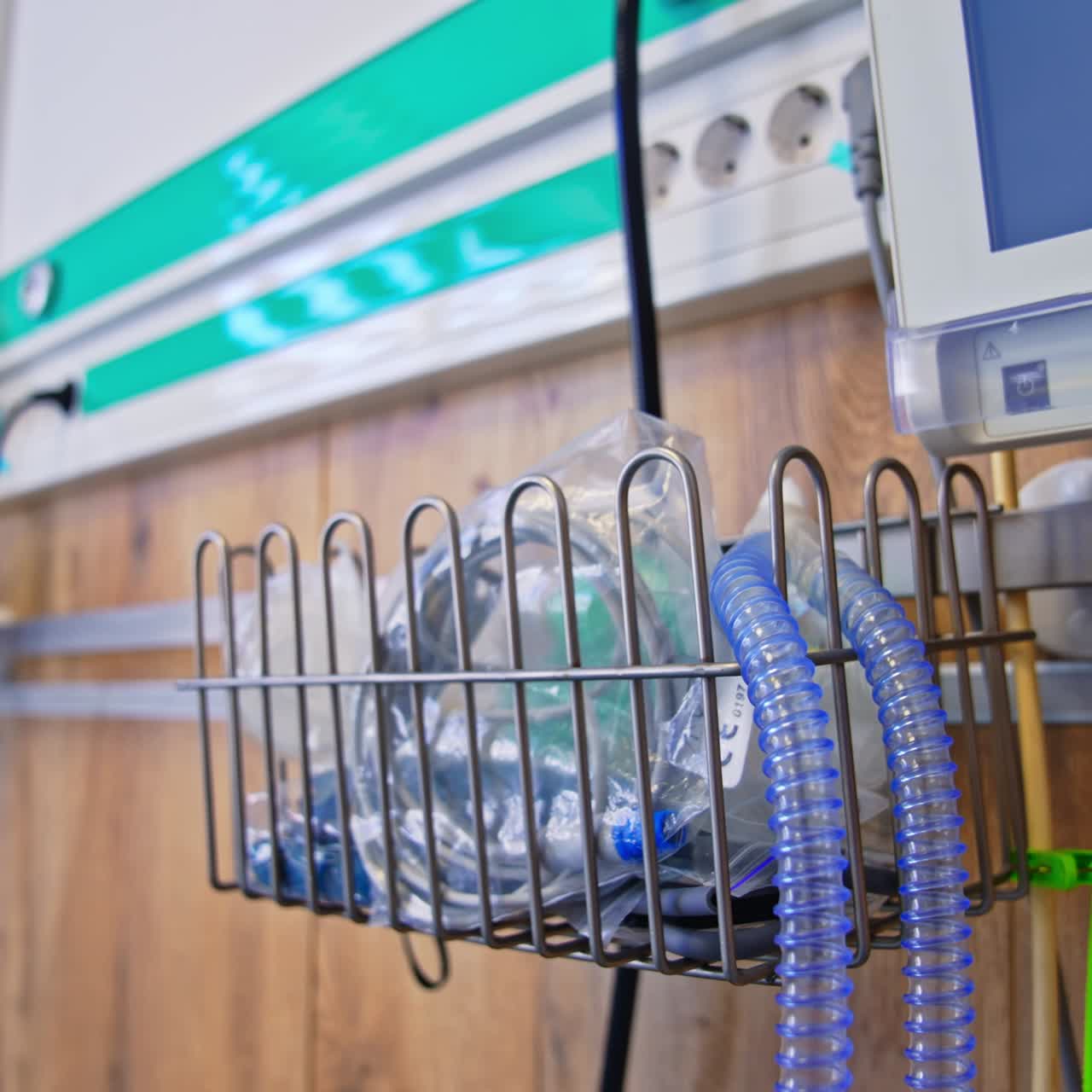 Modern advanced equipment attached to the wall in hospital ward. Tubes and wires from apparatuses in postpartum intensive care unit