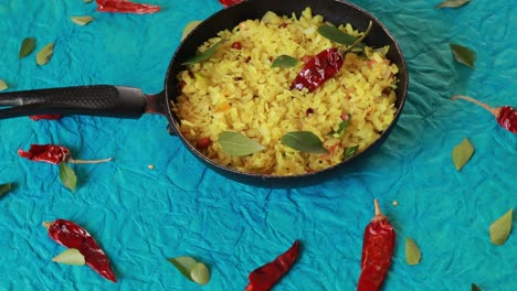 kande pohay or aloo poha is a popular indian breakfast recipe made using flattened rice, usually served with hot tea