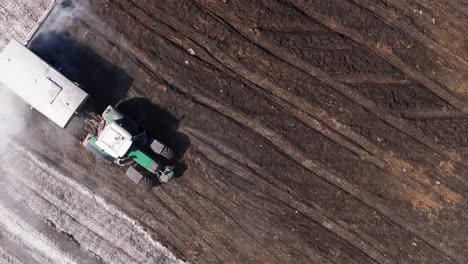 Aerial-View-Of-A-Tractor-Pouring-Lime-Into-The-Soil-To-Neutralize-The-Soil-Acidity