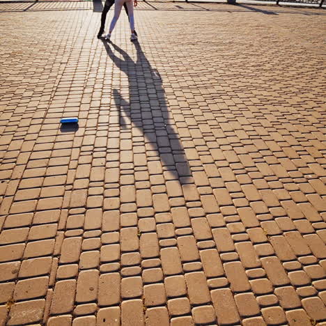 couple is dancing on pavement. legs of two dancers moving together outdoors. professional dancers performing freestyle dance in the street.