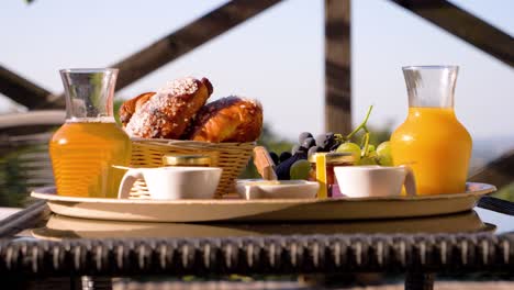 slow orbiting shot of a breakfast selection of pastries and fruit on a table