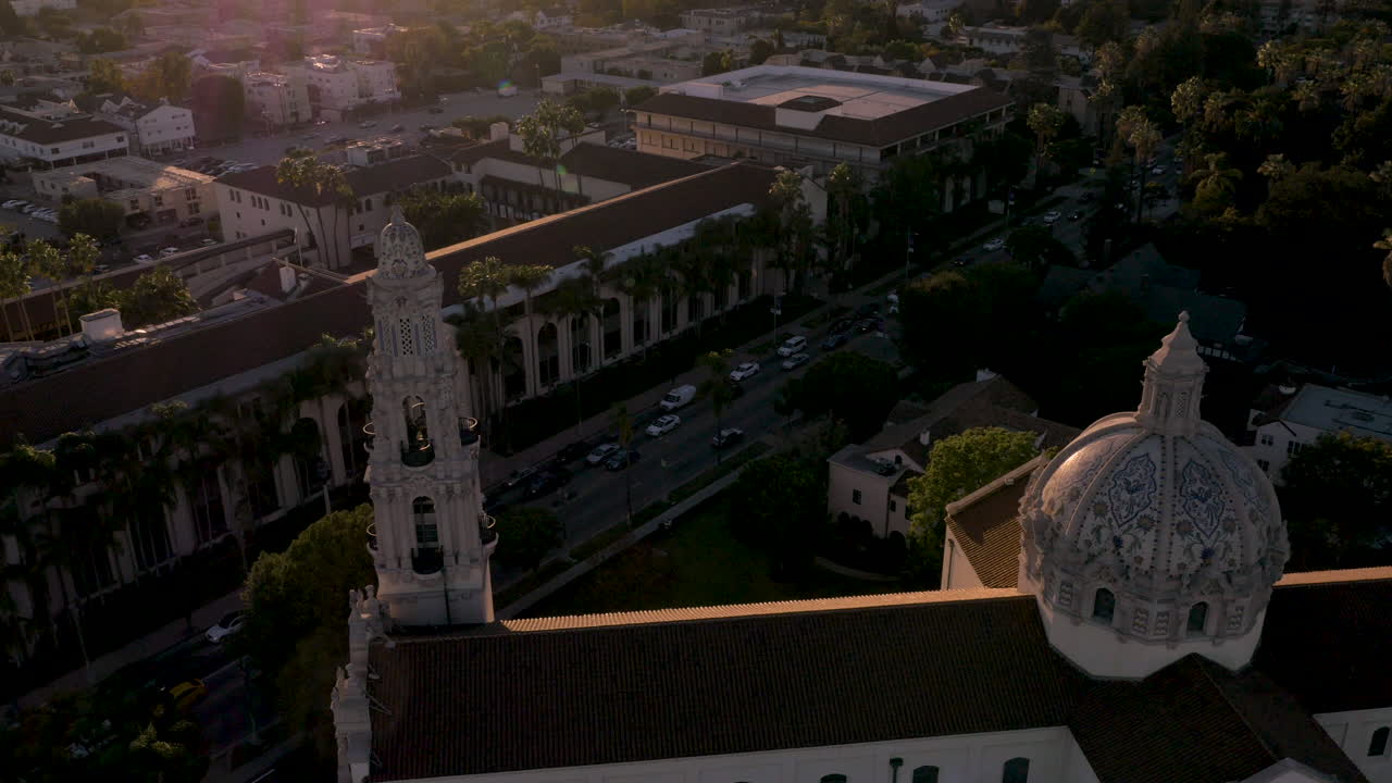 Aerial View of Historic University Building with Dome and Bell Tower at Sunset