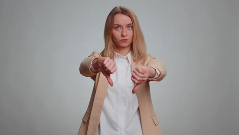 Upset-business-woman-girl-in-suit-showing-thumbs-down-sign-gesture,-disapproval-dissatisfied-dislike