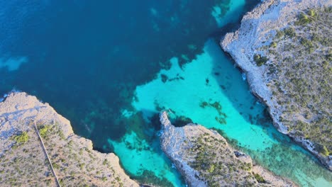 discover the breathtaking beauty of cala varques in porto cristo, majorca. crystal clear waters meet rugged cliffs in this serene coastal paradise, perfect for relaxation and adventure.