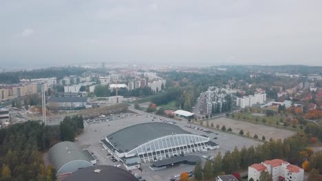 aerial view of a cityscape with an arena and sports facilities