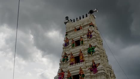 hindu temple gopuram with moving rainy cloudy, sky and trumpet horn. day time, stable shot, 4k