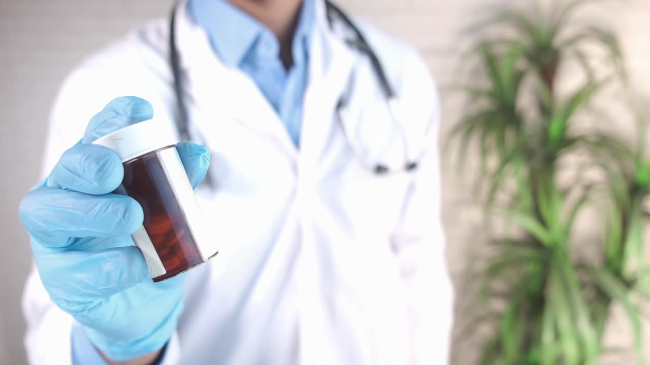 Doctor Holding a Prescription Bottle