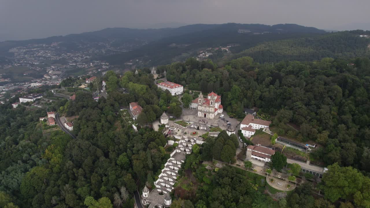 aerial - Bom Jesus Sanctuary and baroque staircase surrounded by dense forest in Braga