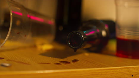 Close-Up-Of-Empty-Wine-And-Beer-Bottles-On-Table-After-House-Party