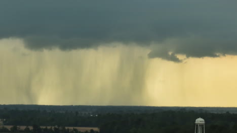 intense rainstorm over reelfoot lake, tennessee, showcasing dramatic rainfall and dark clouds