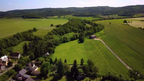 Panoramic-gorgeous-landscape-containing-an-idyllic-Czech-republic-village-in-a-lush-green-valley-in