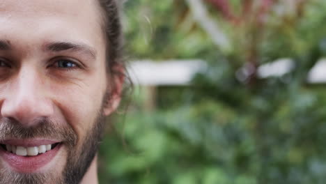 Portrait-of-happy-caucasian-man-smiling-in-garden,-slow-motion,-copy-space