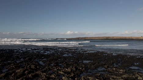 Drone-flight-over-a-reef-in-Fuerteventura-playa-blanca-with-surfers