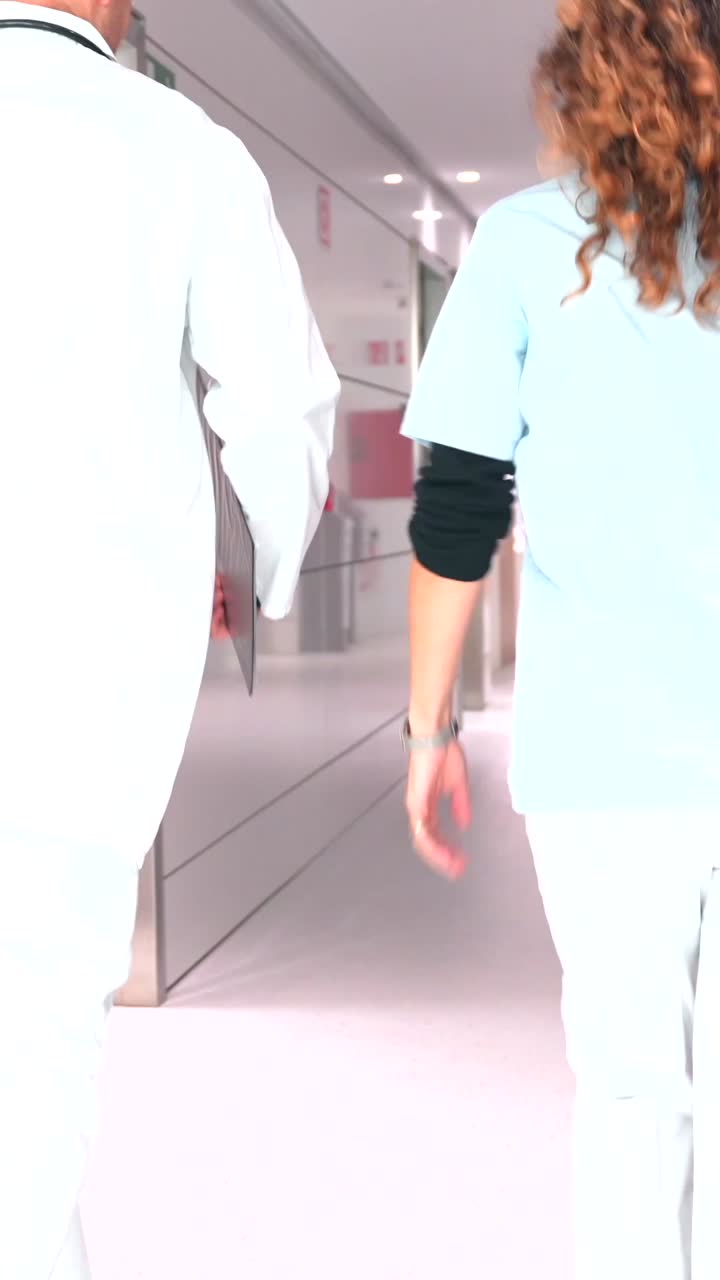 Doctors and Nurses Running in Hospital Corridor