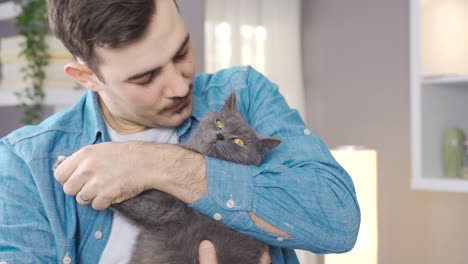 Young-man-kissing-and-hugging-his-cat.