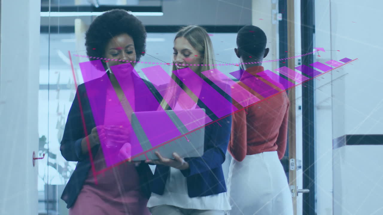 Collaborating businesswomen using laptop with colorful data visualization in office