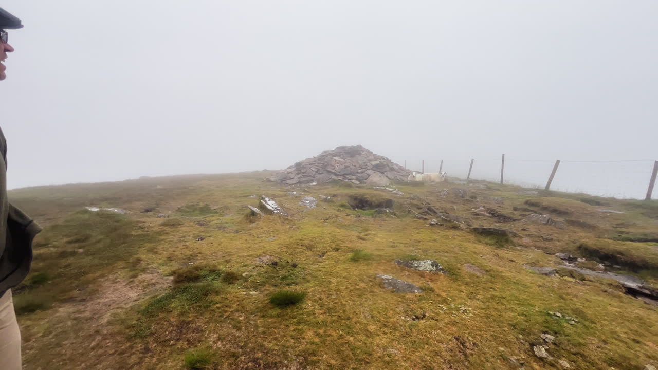 A man walking on the hill og conor pass Ireland- foggy hill of Ireland
