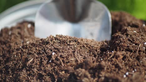 potting mix in a garden container with a shovel