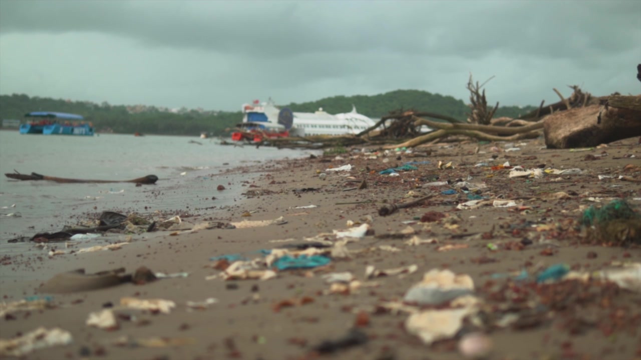 sea tainted by waste, highlighting the urgent need for environmental conservation efforts. Luxurious yacht in the background serves as a stark contrast to the damage inflicted on the marine ecosystem