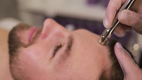 man receiving facial treatment