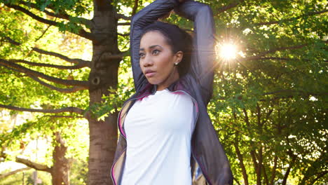 young black woman stretches before exercise in brooklyn park