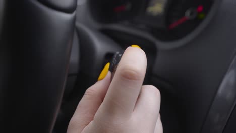 person adjusting car controls