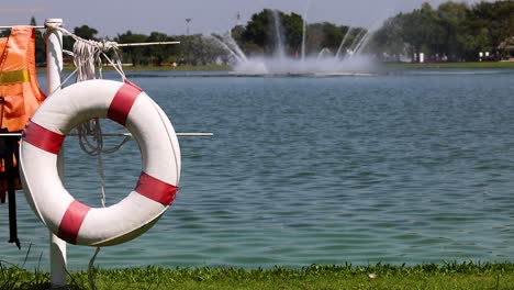 life jackets and ring by a serene lake