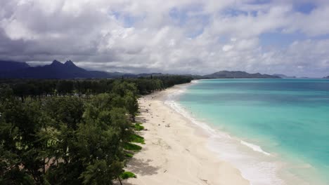 Drone-shot-of-Oahu's-white-sand-coastline-at-midday