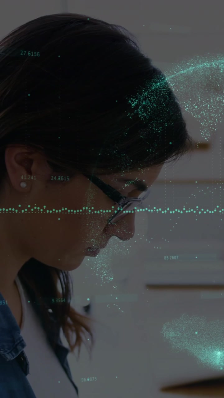 Animation of graphs and globe over woman working on laptop