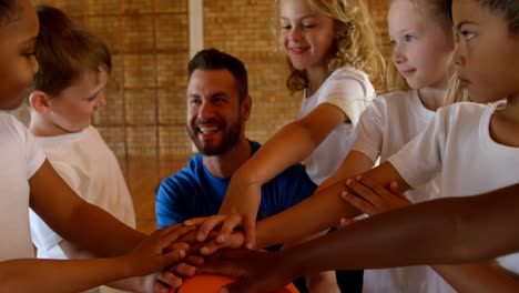 basketball coach and schoolkids forming hand stack in the basketball court 4k