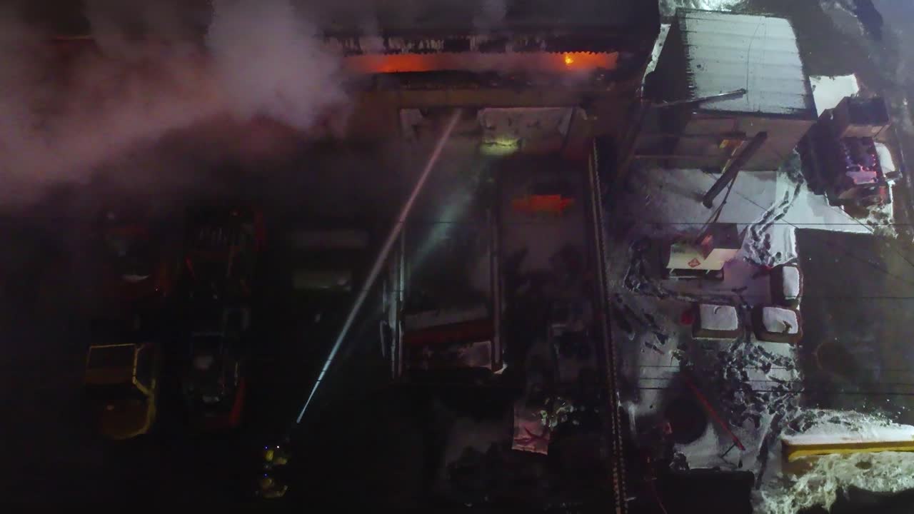 impressive shot of firefighter extinguishing a house fire