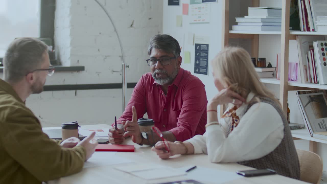 Multi-Ethnic Team of Business Professionals Having Meeting in Modern Office