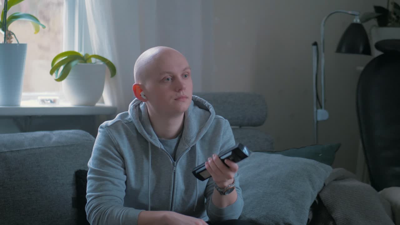 Man boringly sapping through the TV channels