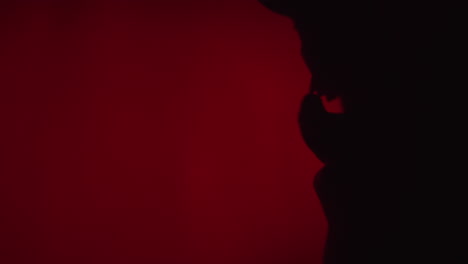 silhouette of a person against a dark red background
