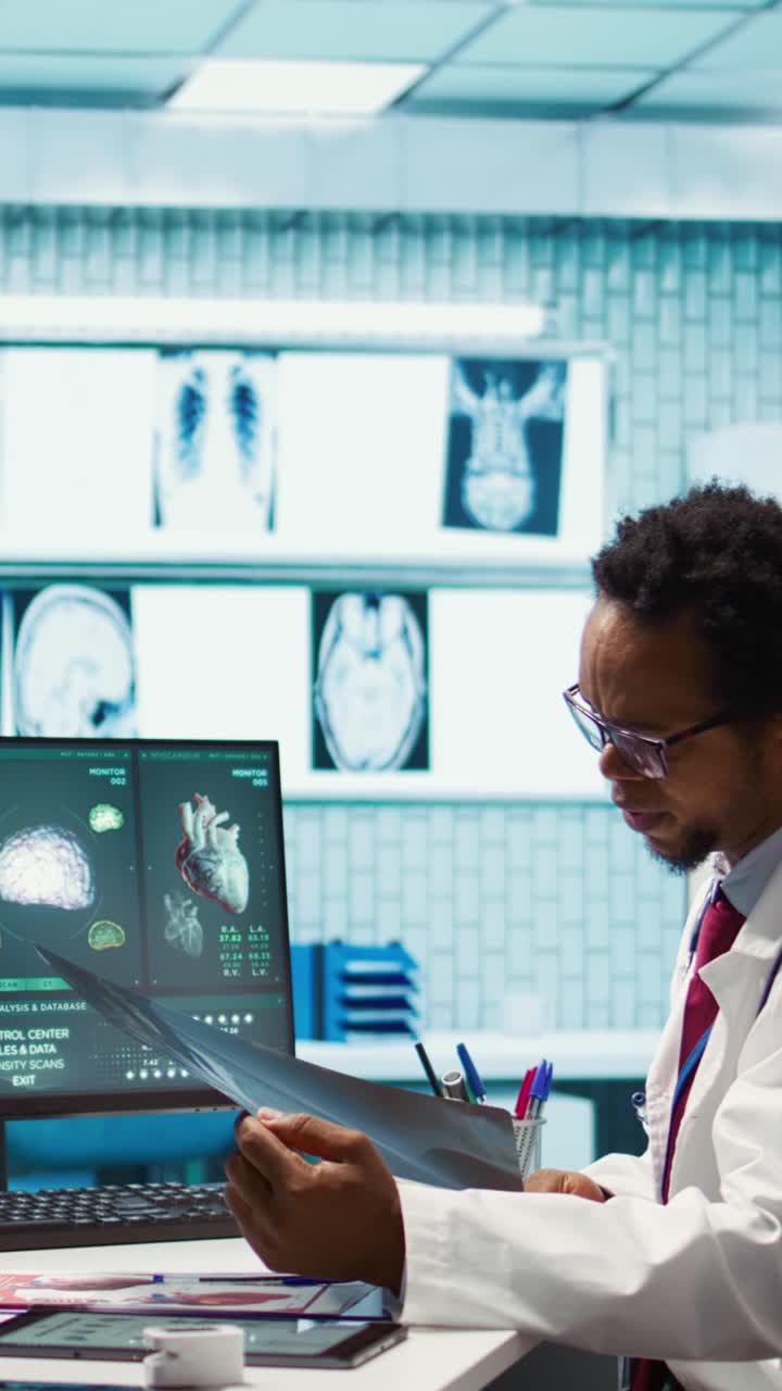 Physician reviewing MRI scan and x ray results with a patient in medical office