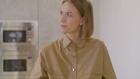 Pregnant-Woman-Sitting-At-Table-Eating-Fruit-And-Caressing-Her-Belly-Coworker-In-Canteen