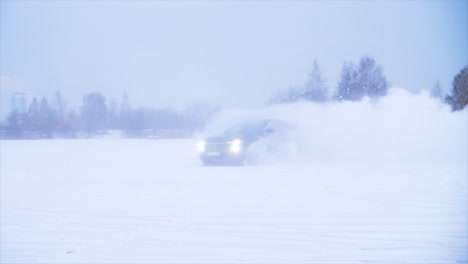 suv drifting in snow-covered landscape