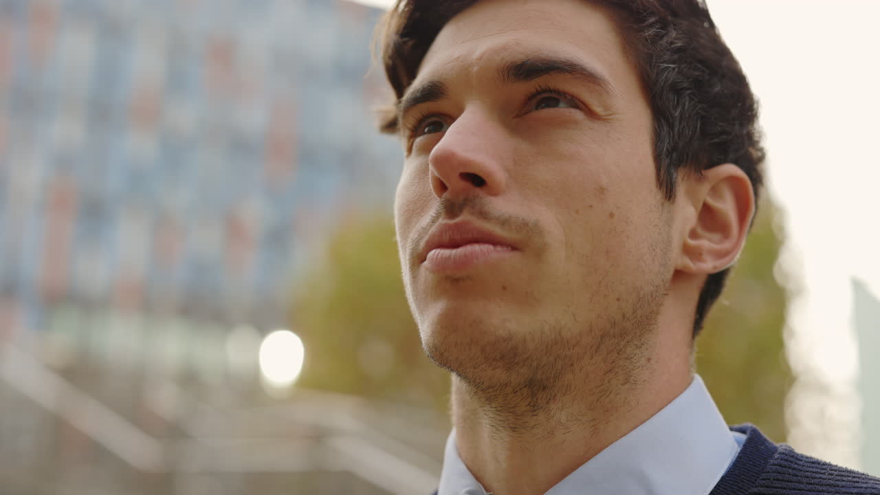 Portrait of a man looking up in the city