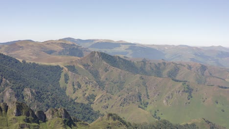 flyover unspoiled misty mountain landscape, rugged green terrain