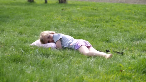 cute summer girl lying in green grass